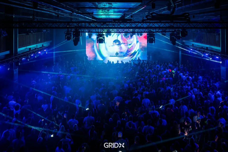 GRIDX Event Hall with an audience, stage and production lighting